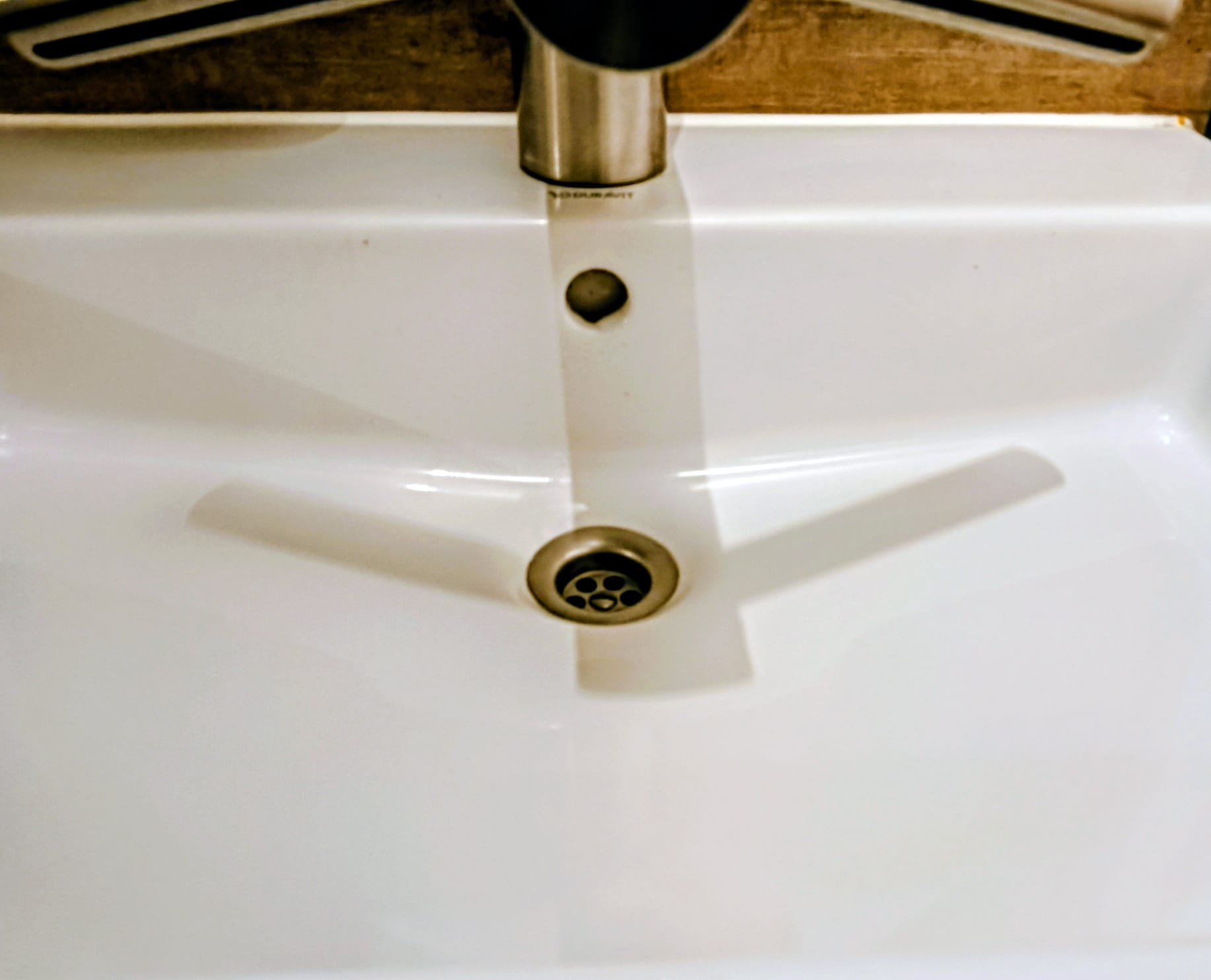 Dezelfde wastafel schoon en zonder aanslag, na de schoonmaak door ProFinish Cleaning